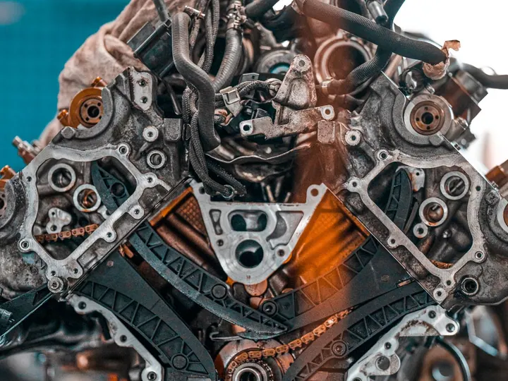 Disassembled car engine on a workshop bench