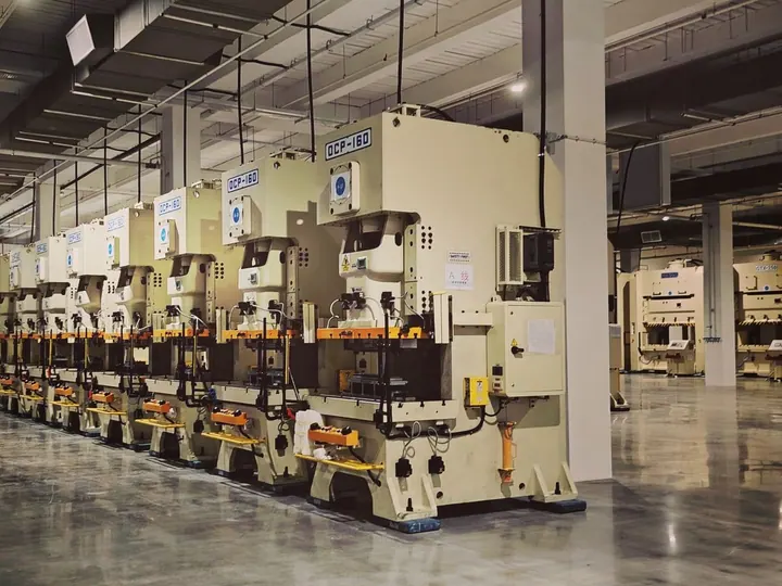 Row of large industrial presses on a factory floor