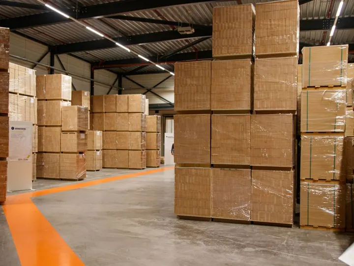 Stacks of wrapped cardboard boxes in an industrial warehouse