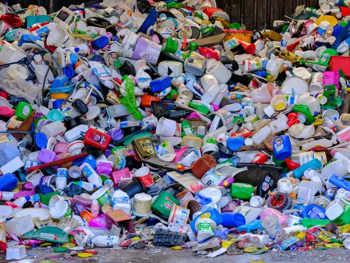 Pile of used plastic bottles and containers at a recycling center